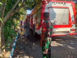 Babinsa 0816/01 Sarirogo gotong royong dengan warga padamkan kebakaran gudang cat kaleng.